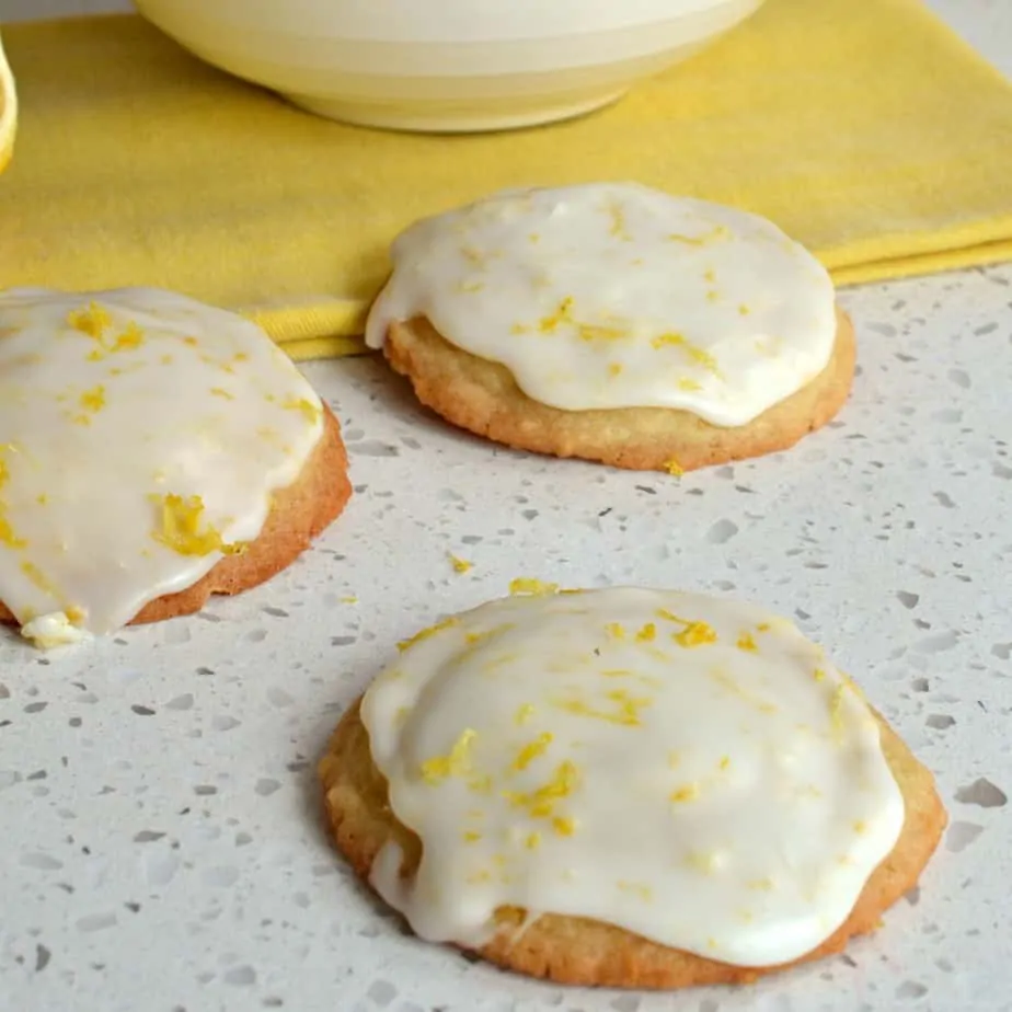 These family friendly delectable soft lemon cookies are perfect for spring with a super easy four ingredient tangy lemon icing.