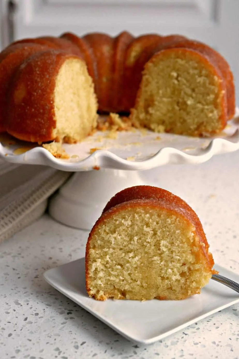 This scrumptious Kentucky Butter Cake Recipe is a super moist vanilla butter pound cake with a sweet butter sauce that soaks through the cake.