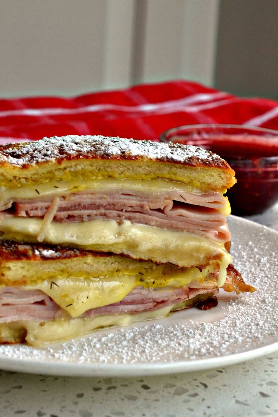 The Monte Cristo Sandwich is made with ham, turkey. Swiss Cheese and white bread that has been dipped in egg batter. 