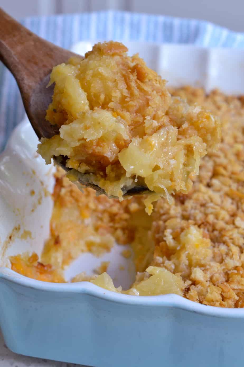 A spoonful of cheesy pineapple casserole