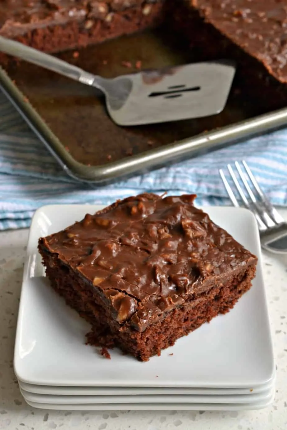 An easy moist chocolate cake baked in a jelly roll pan and topped with a luscious chocolate fudge frosting.
