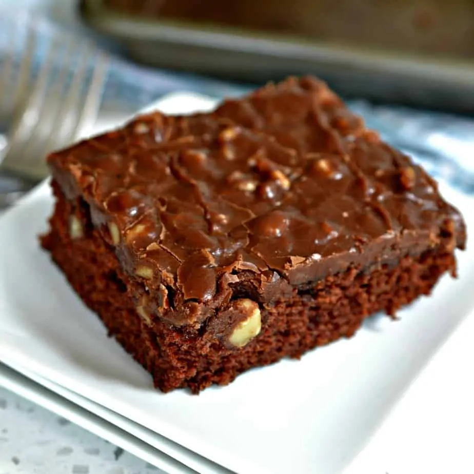 Texas Sheet Cake is a quick and easy moist decadent chocolate cake covered with a chocolate fudge walnut frosting.
