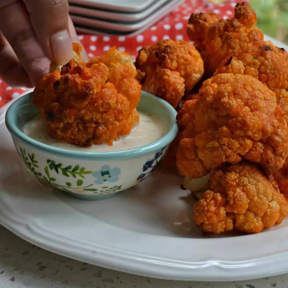 These Buffalo Cauliflower bites are smothered with buffalo sauce then baked and broiled to golden crispy perfection.