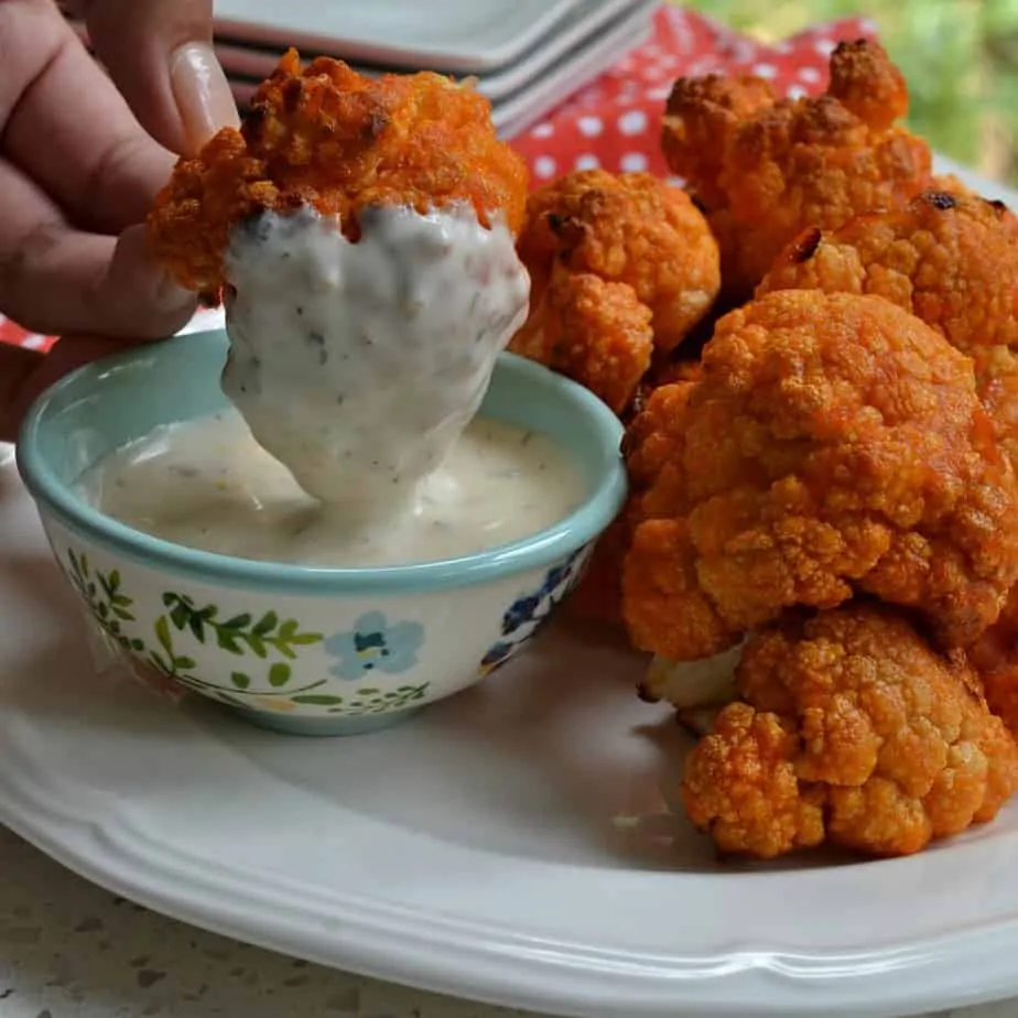  These delicious baked Buffalo Cauliflower bites are just as good as buffalo chicken with a lot less calories and fat.