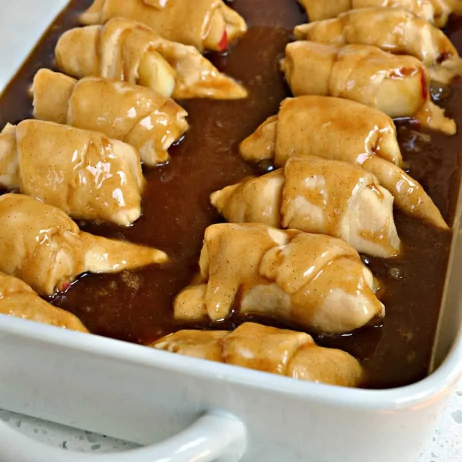 Sweet Apple Dumplings made easy with refrigerated crescent roll dough cooked in a cinnamon butter caramel glaze.