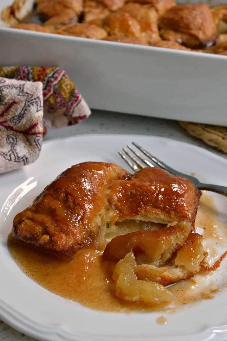 These scrumptious Apple Dumplings have apple slices rolled in dough and baked in butter, brown sugar and cinnamon.