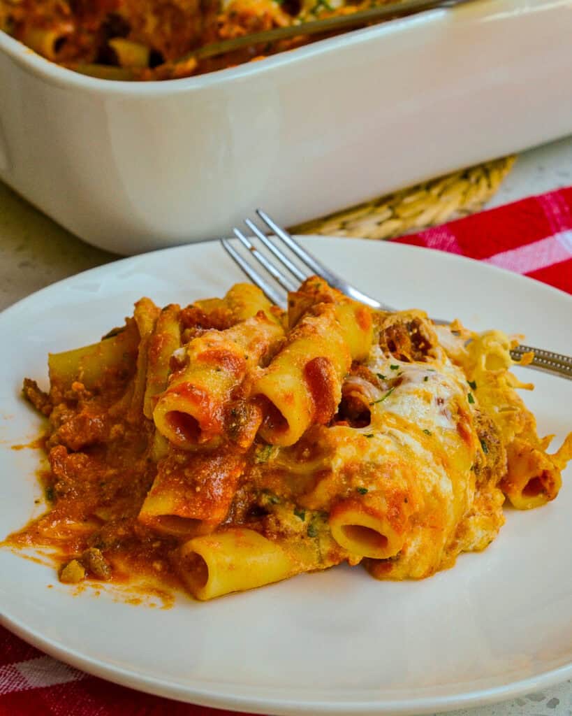 Baked Ziti on a white plate with a fork.