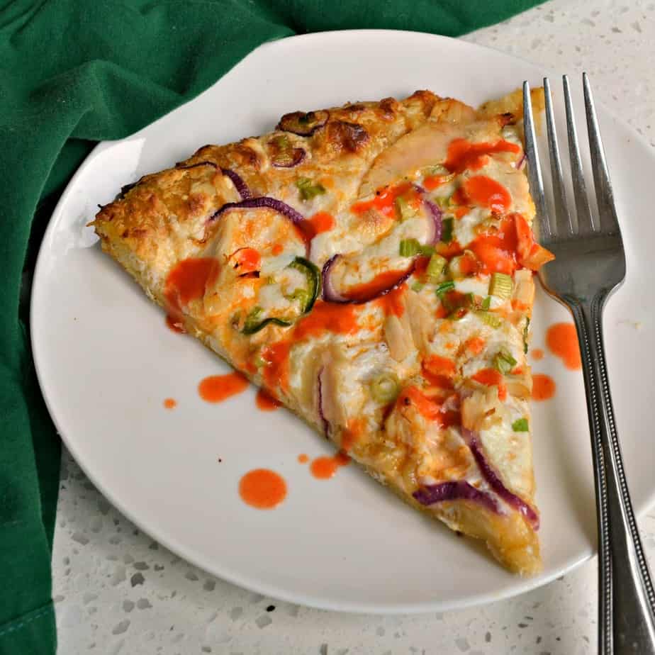 This Buffalo Chicken Pizza is topped with ranch, hot sauce, rotisserie chicken, red onions, scallions and mozzarella.