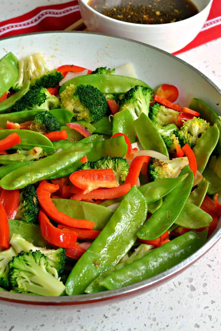 Pea pods, red peppers and broccoli florets are the perfect vegetables for this tasty Garlic Shrimp Stir Fry