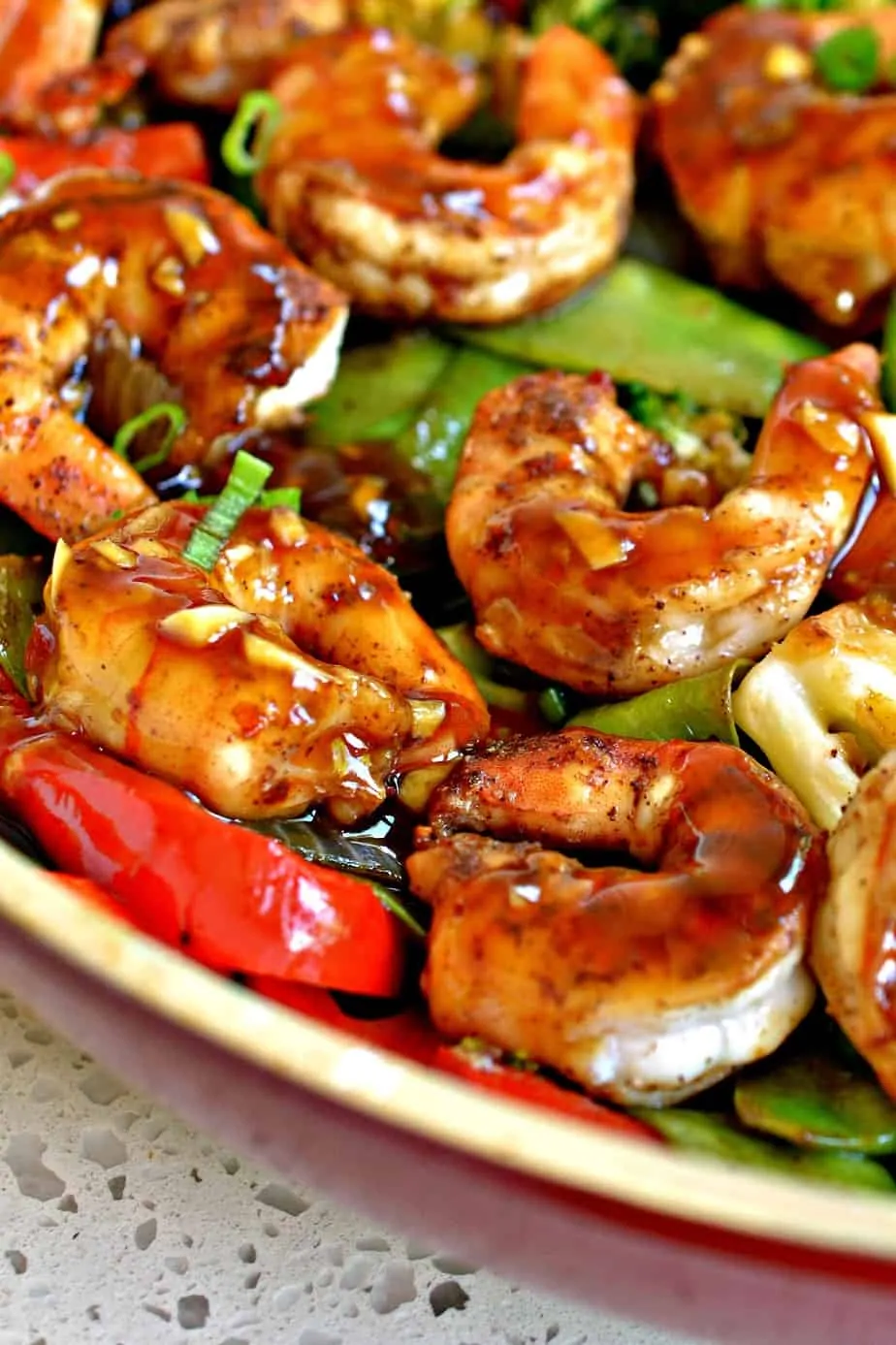 Garlic Shrimp Stir Fry brings together broccoli, snow peas, red bell pepper, onion and succulent shrimp in a honey garlic sauce.