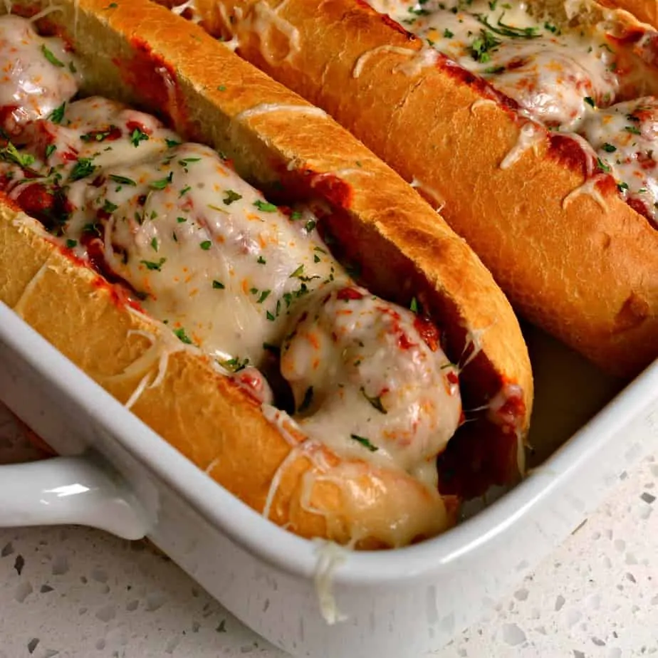 Italian Meatball Subs combine homemade meatballs with pasta sauce and melted mozzarella all on buttered toasted sub rolls.