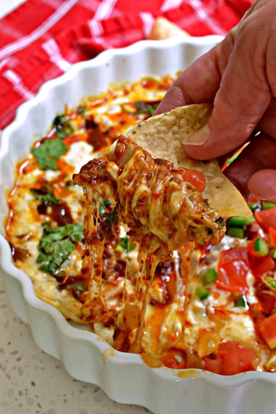 Queso Fundido is a dip with creamy melted cheese, chorizo, spices and toppings served with tortilla chips or tortillas. 