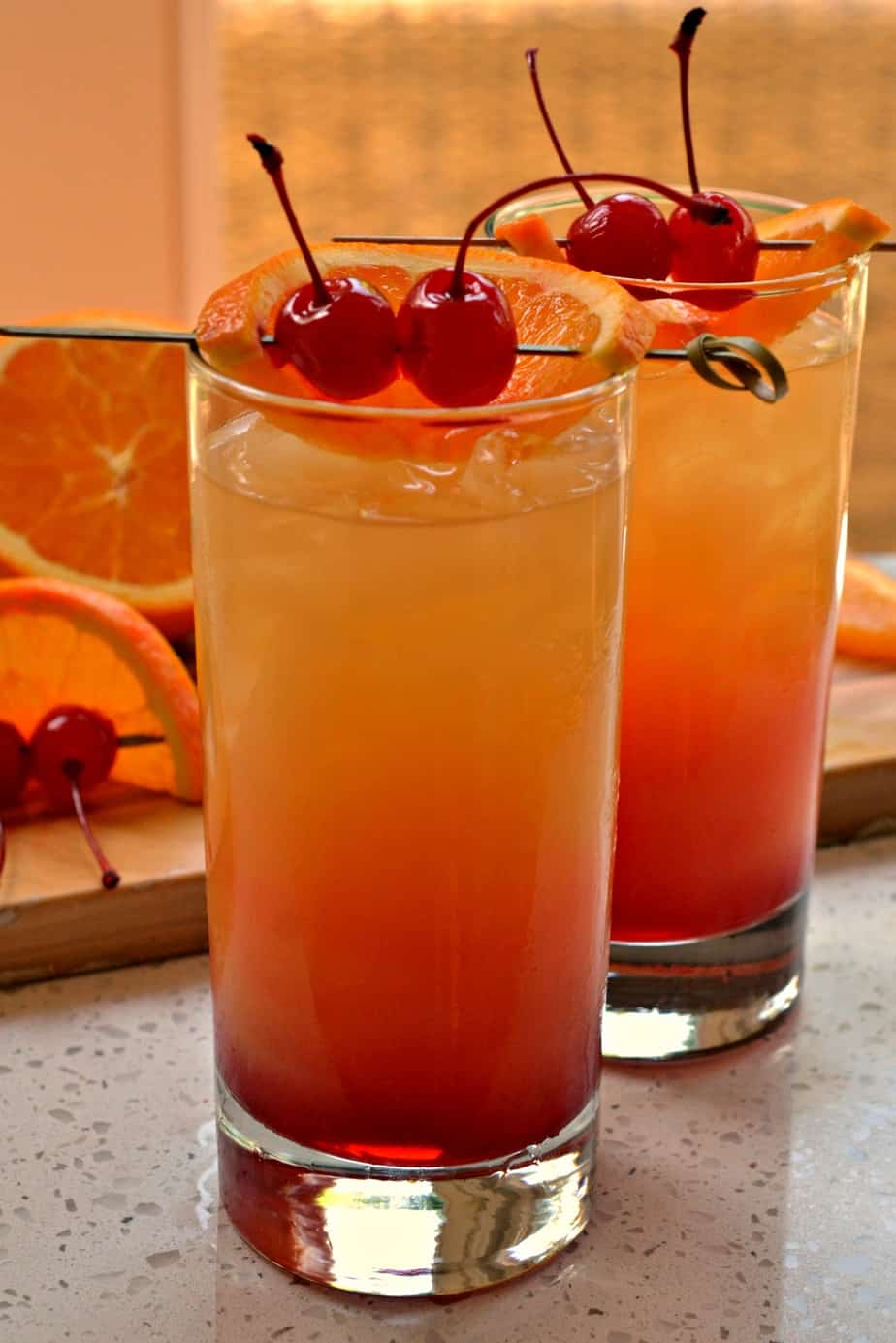This beautiful summer party worthy Tequila Sunrise cocktail is made easy with three ingredients in less than three minutes. 