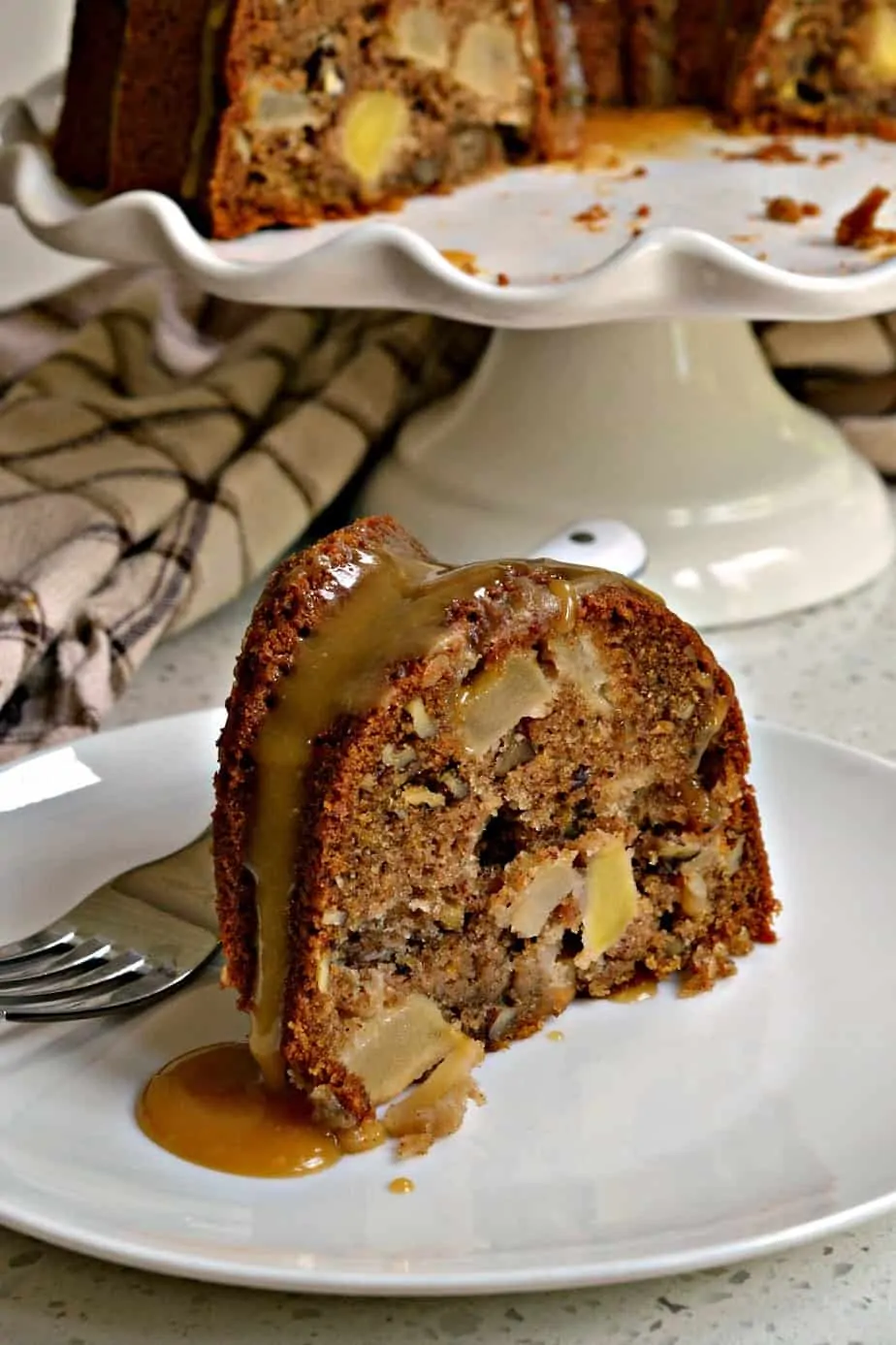 A moist Apple Cake with chunks of fresh apples and pecans all topped with an easy four ingredient caramel drizzle.