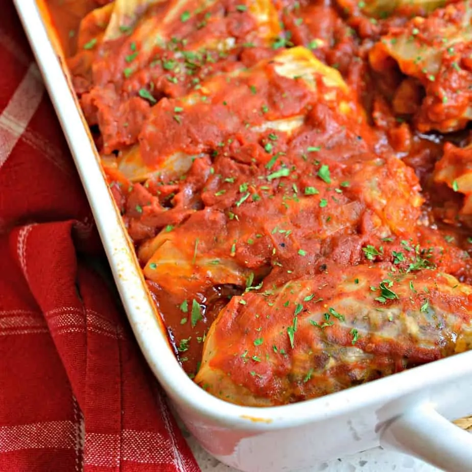 Family friendly Cabbage Rolls stuffed with ground pork and rice smothered in a sweet and tangy tomato sauce. 