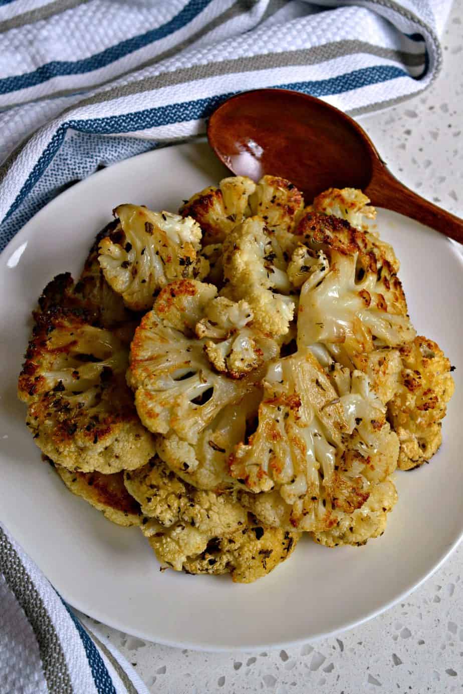 This roasted cauliflower side dish is made with wholesome ingredients like olive oil, Parmesan cheese, herbs and spices.