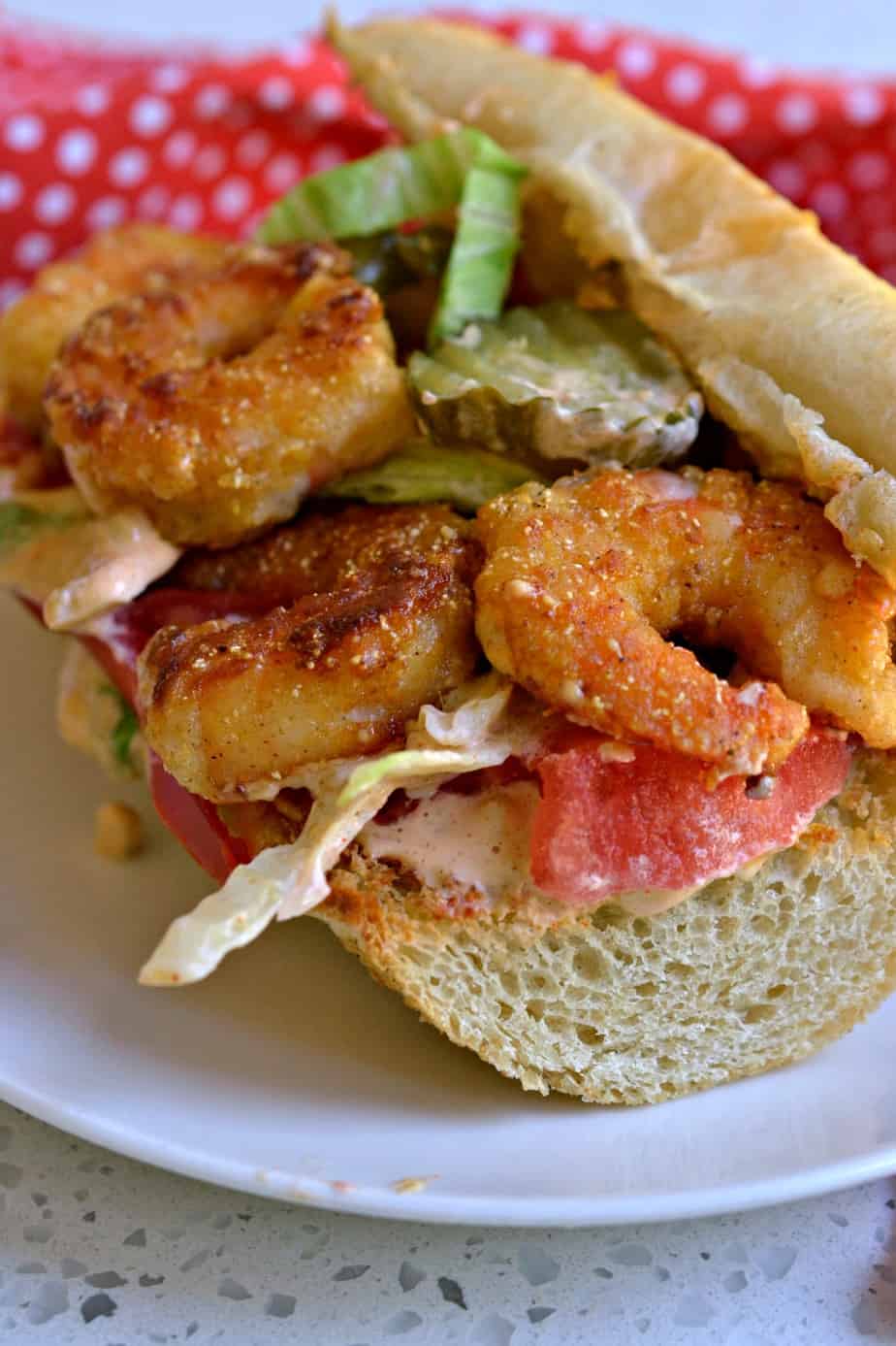 These Shrimp Po Boy sandwiches are filled with crispy fried shrimp and topped with an amazing sassy Remoulade Sauce.