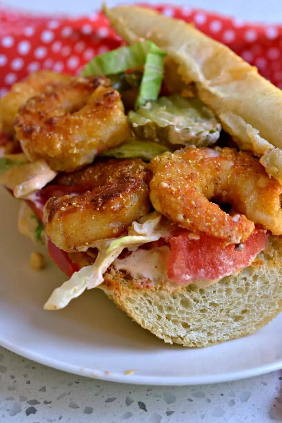 These Shrimp Po Boy sandwiches are filled with crispy fried shrimp and topped with an amazing sassy Remoulade Sauce.