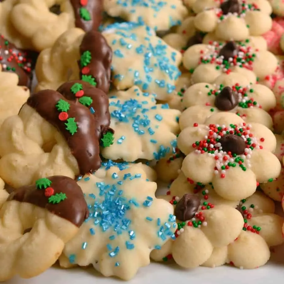 These melt in your mouth adorable little buttery Spritz Cookies are made easy with seven ingredients in a cookie press.