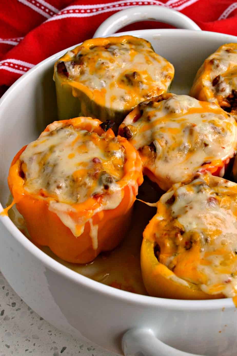 These fun Mexican Stuffed Peppers are filled with seasoned ground beef, onions, garlic, fire roasted tomatoes, and rice, 