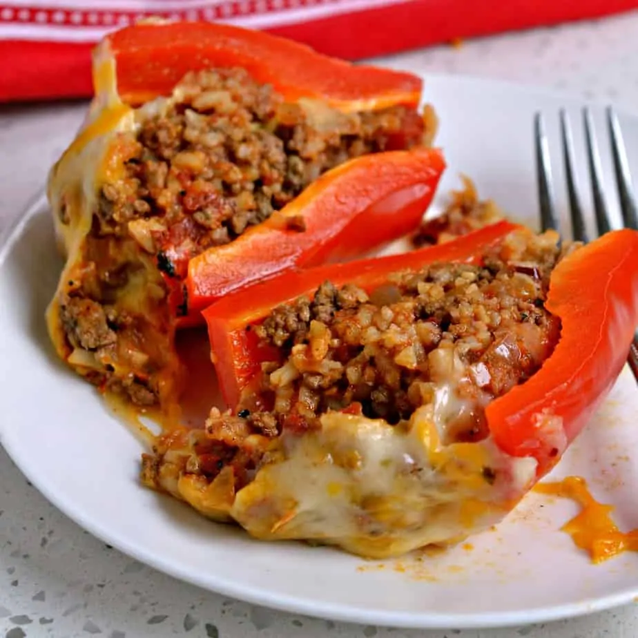 These festive, fun, and easy Mexican Stuffed Peppers are loaded with seasoned ground beef, onions, tomatoes and rice,.