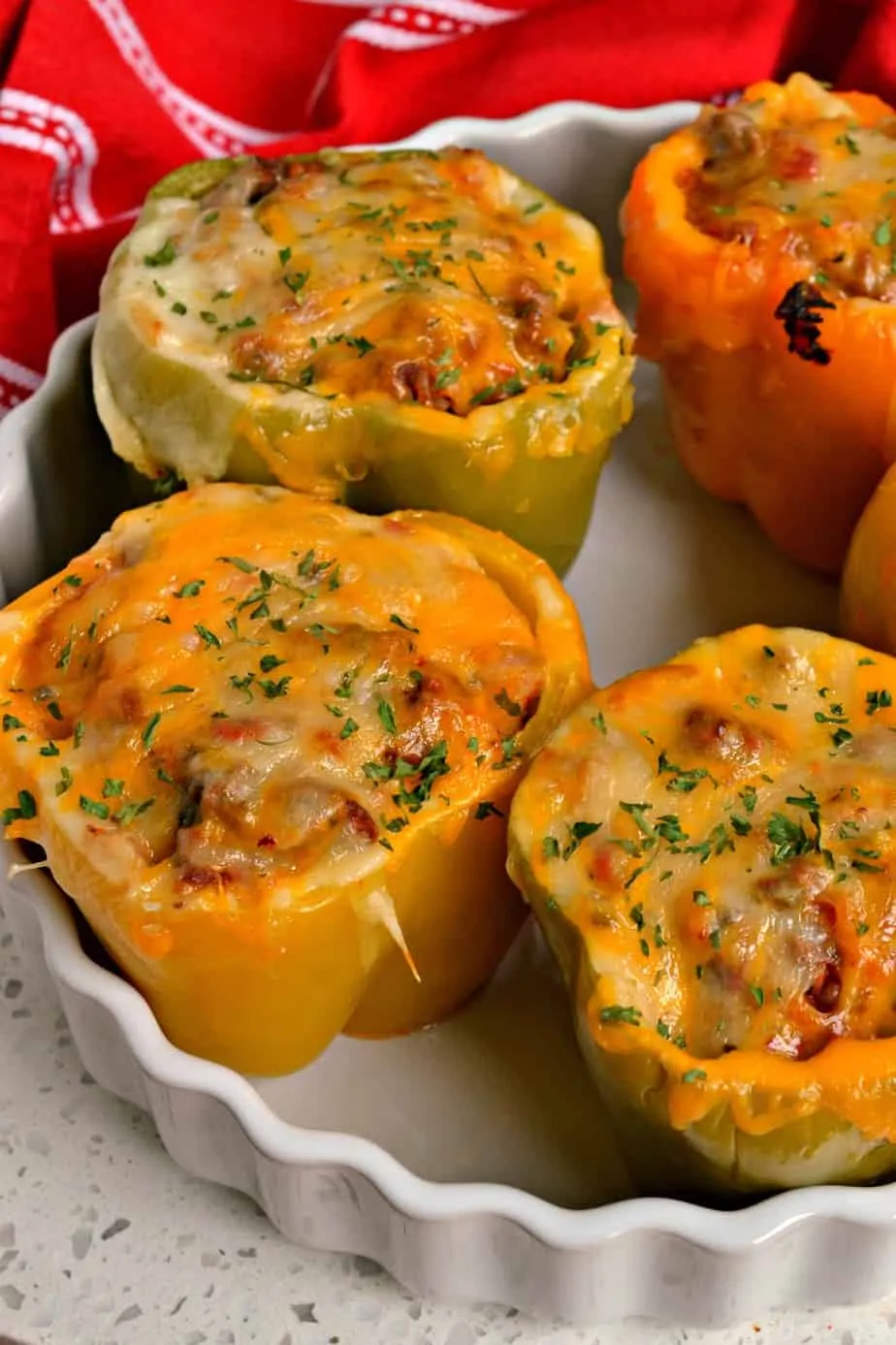 These festive, fun, and easy Mexican Stuffed Peppers are topped with sharp cheddar and zesty pepper jack cheese.