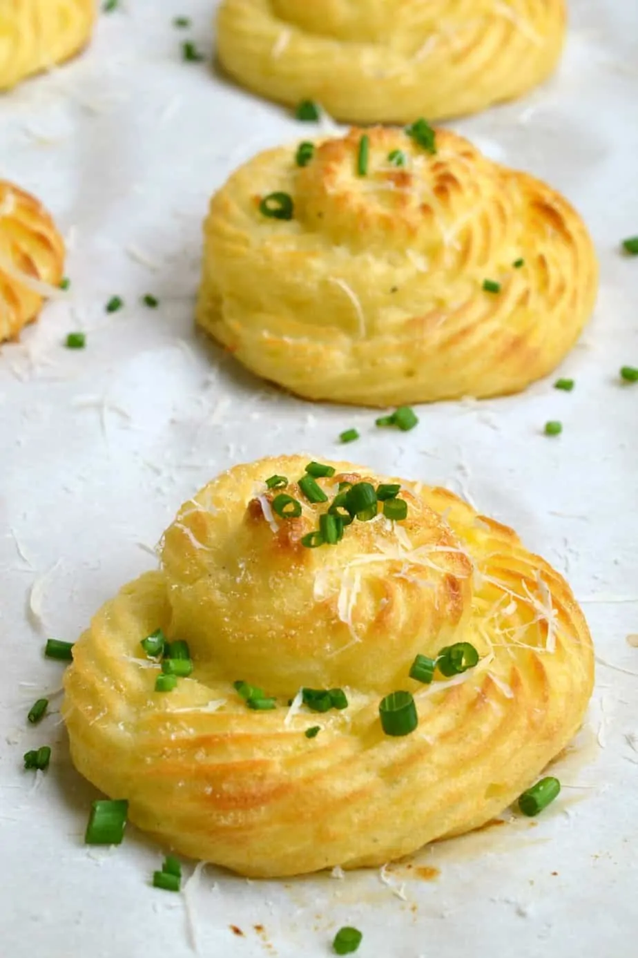 Duchess Potatoes are mashed potatoes that are piped, brushed with butter and baked till the edges are crispy and browned. 