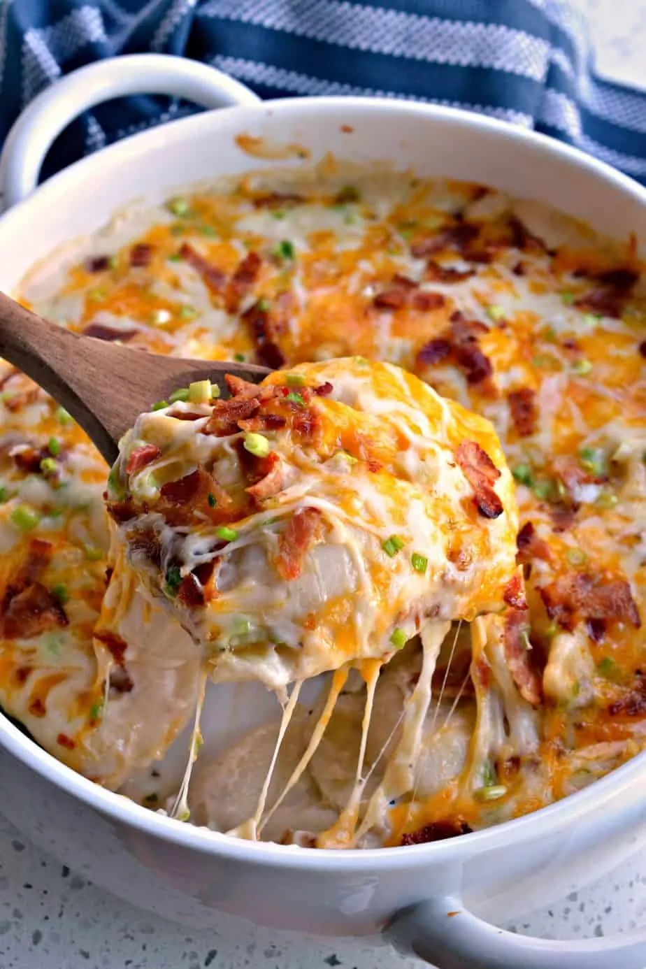 This Cheesy Pierogi Casserole is layered with alfredo sauce, green onions, bacon and shredded mozzarella and cheddar cheese. 