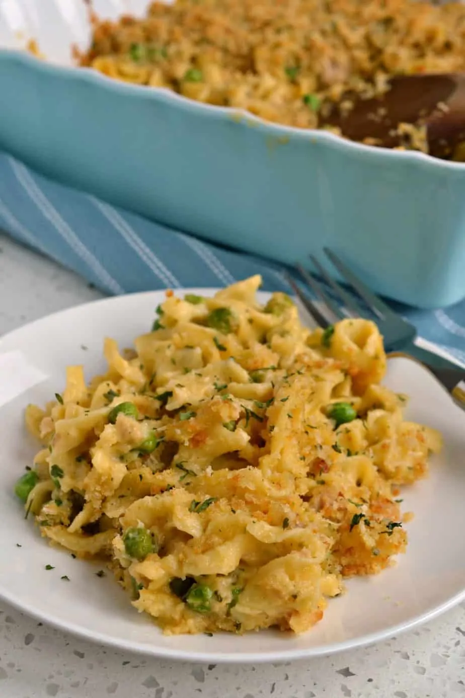Family friendly Tuna Noodle Casserole made with a simple cheddar cheese sauce and crunchy buttery Parmesan breadcrumbs.