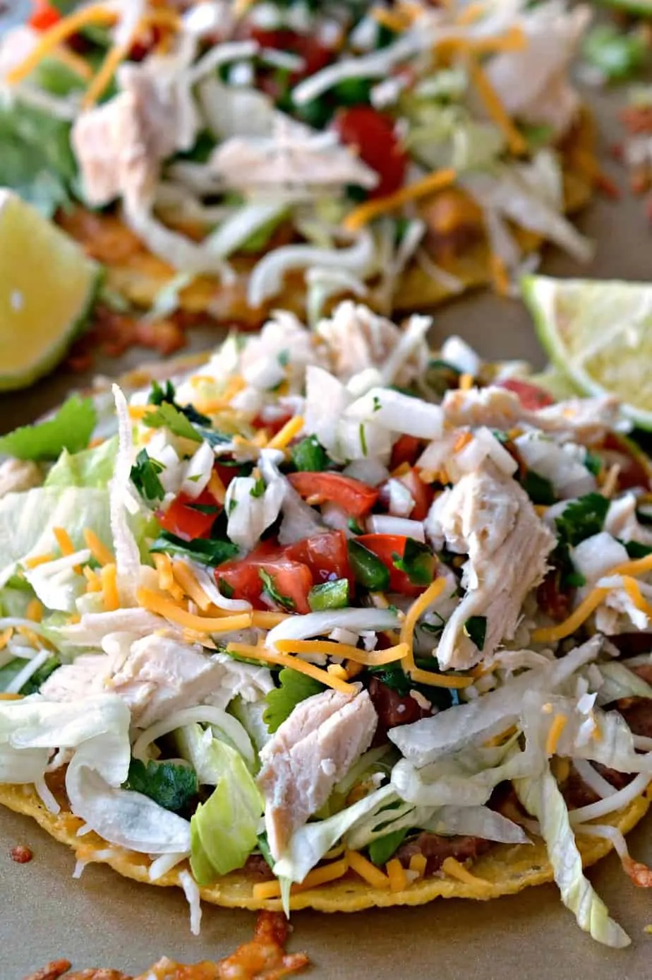 Fun and Easy Tex Mex Chicken Tostadas made with homemade pico de gallo, rotisserie chicken, and plenty cheese. 