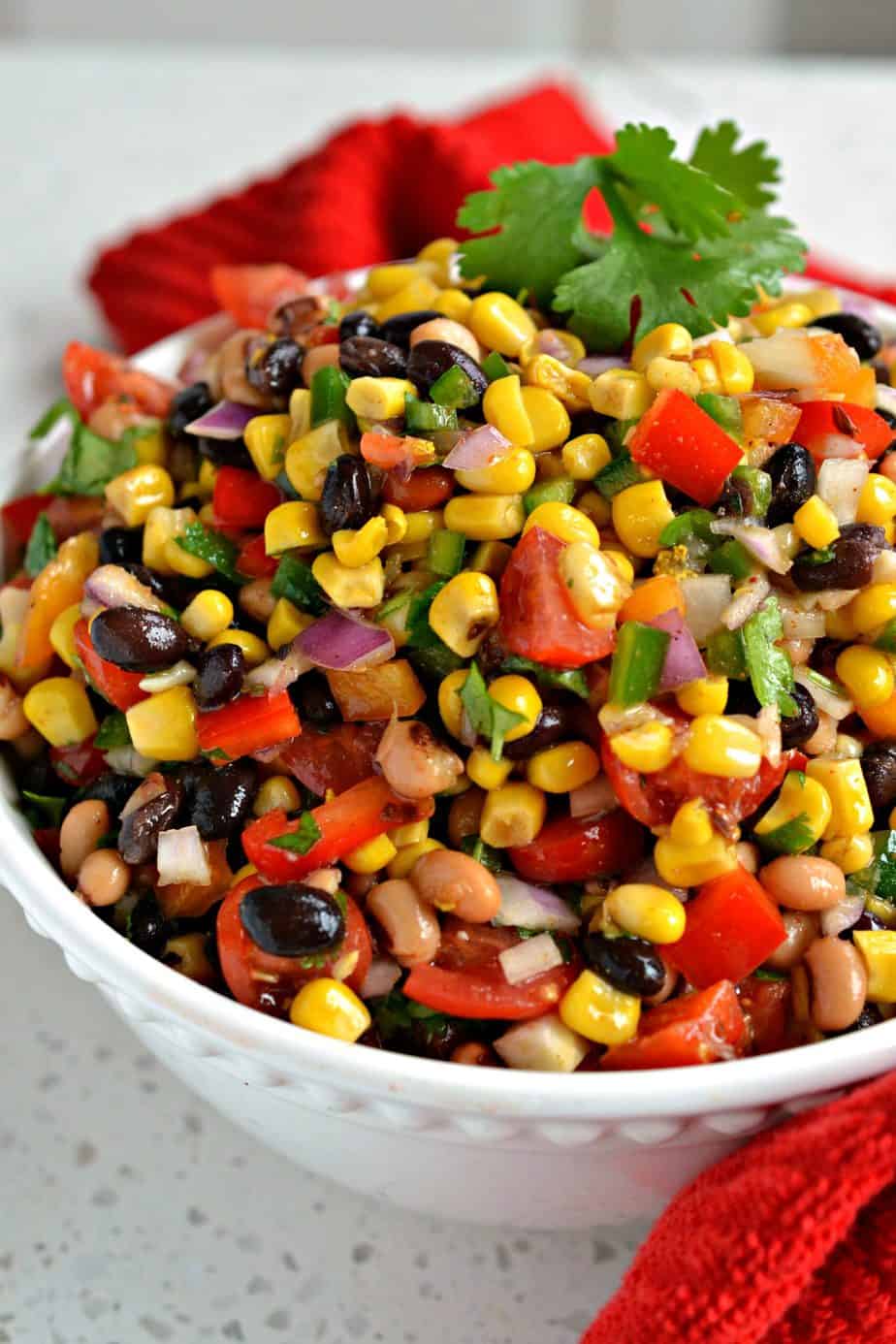 This tasty easy Cowboy Caviar is a cornucopia of beans, black eyed peas, and vegetables all in a sweet lime vinaigrette. 