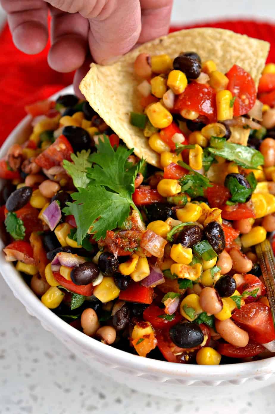 Cowboy caviar on a tortilla chip.