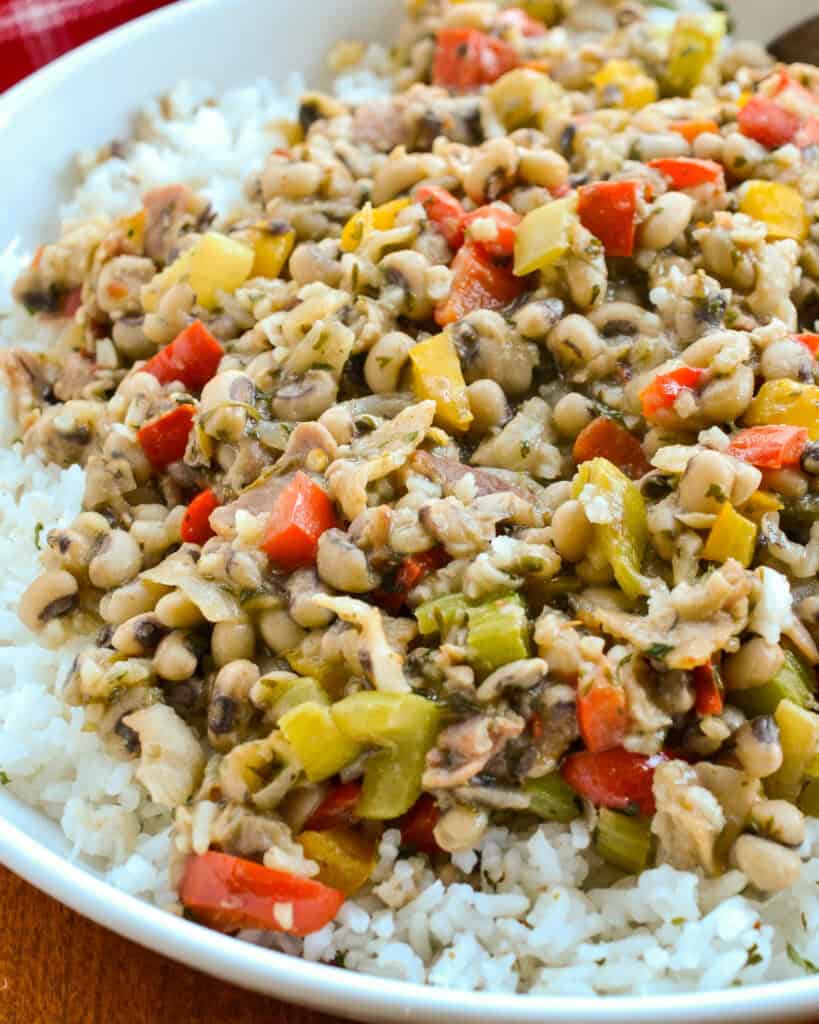 A close up view of hoppin' John over rice. 
