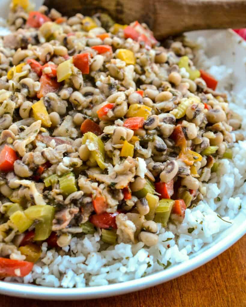 A Southern black-eyed pea dish with bacon, onions, celery, bell peppers, and garlic served over white rice. 