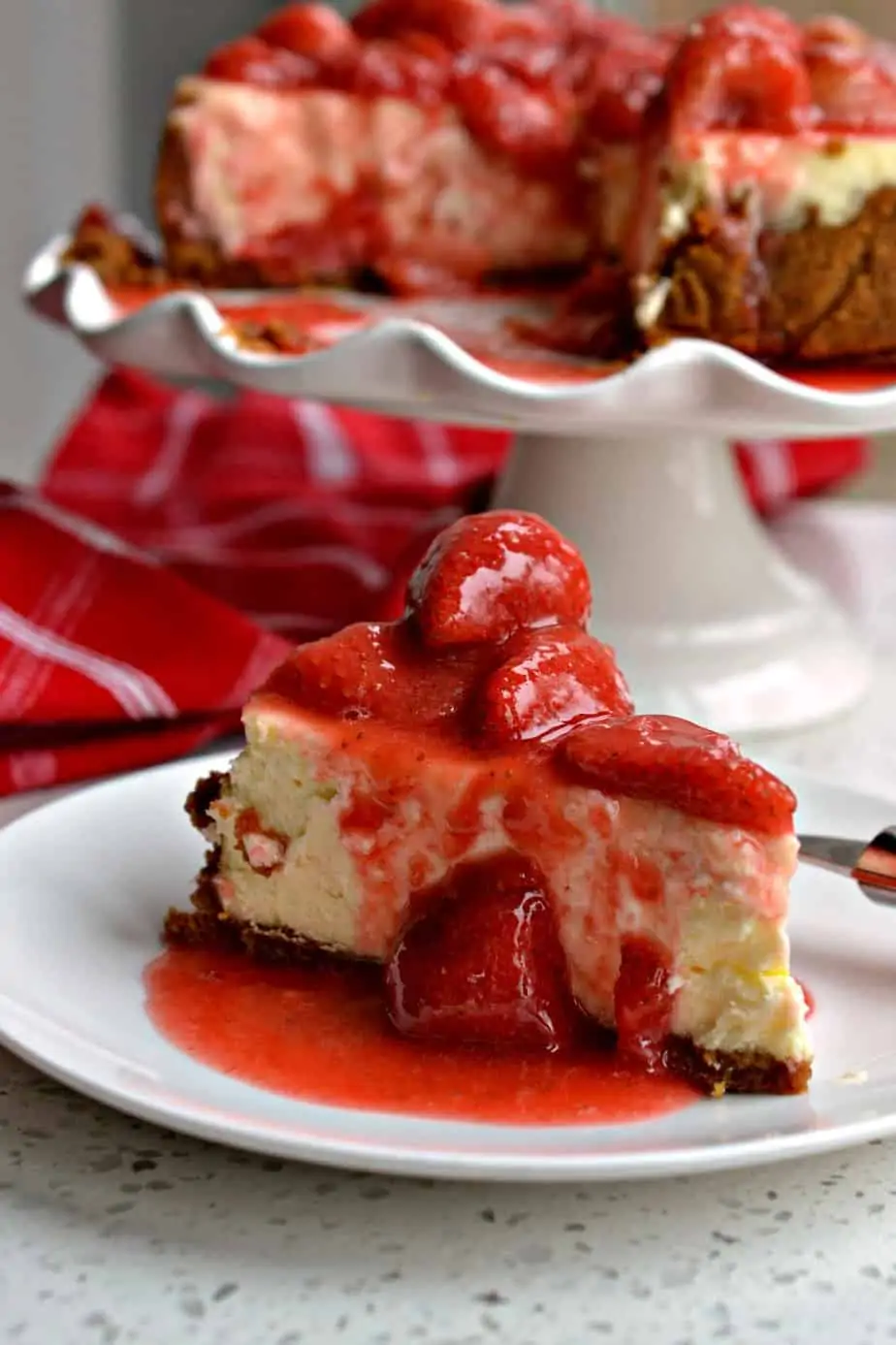 Delectable Strawberry Cheesecake is a cinch to make with a three ingredient graham cracker crust and fresh strawberry sauce.
