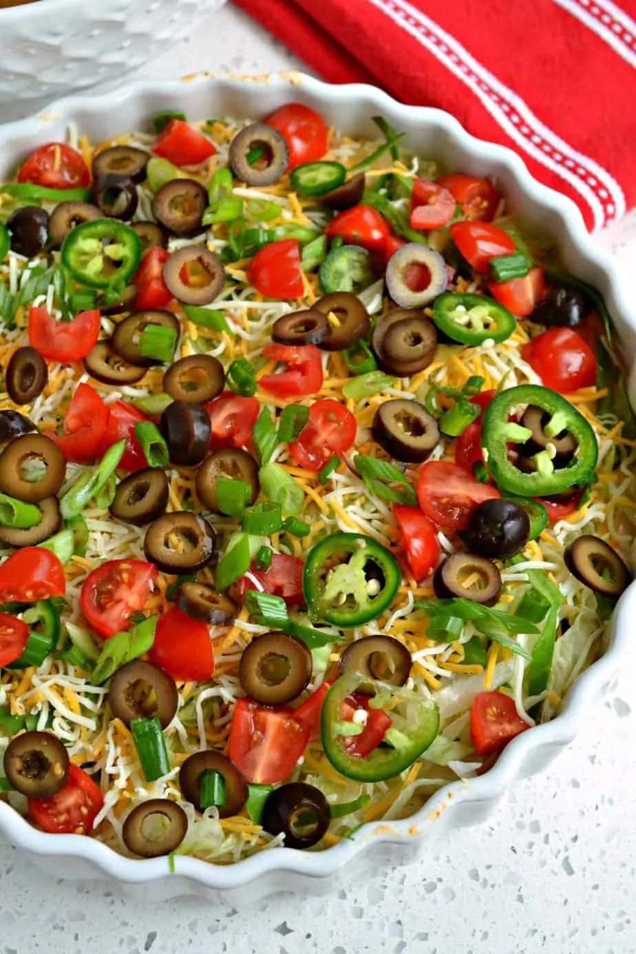 This scrumptious Taco Dip Recipe is made in less than 10 minutes complete with a beautiful array of toppings