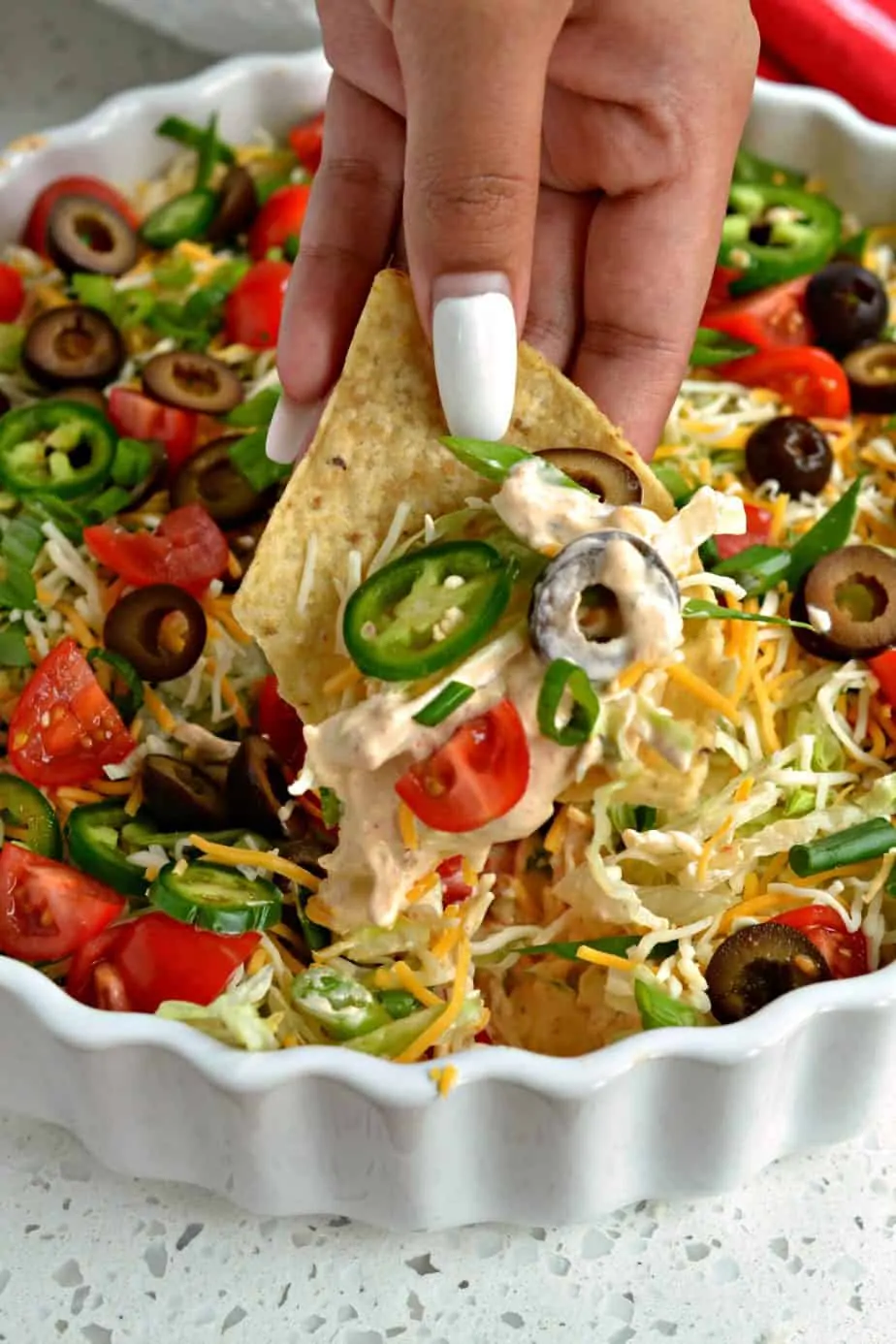This fun, quick, and easy layer Taco Dip comes together in less than 10 minutes and is always a hit at parties, potlucks, and family reunions.