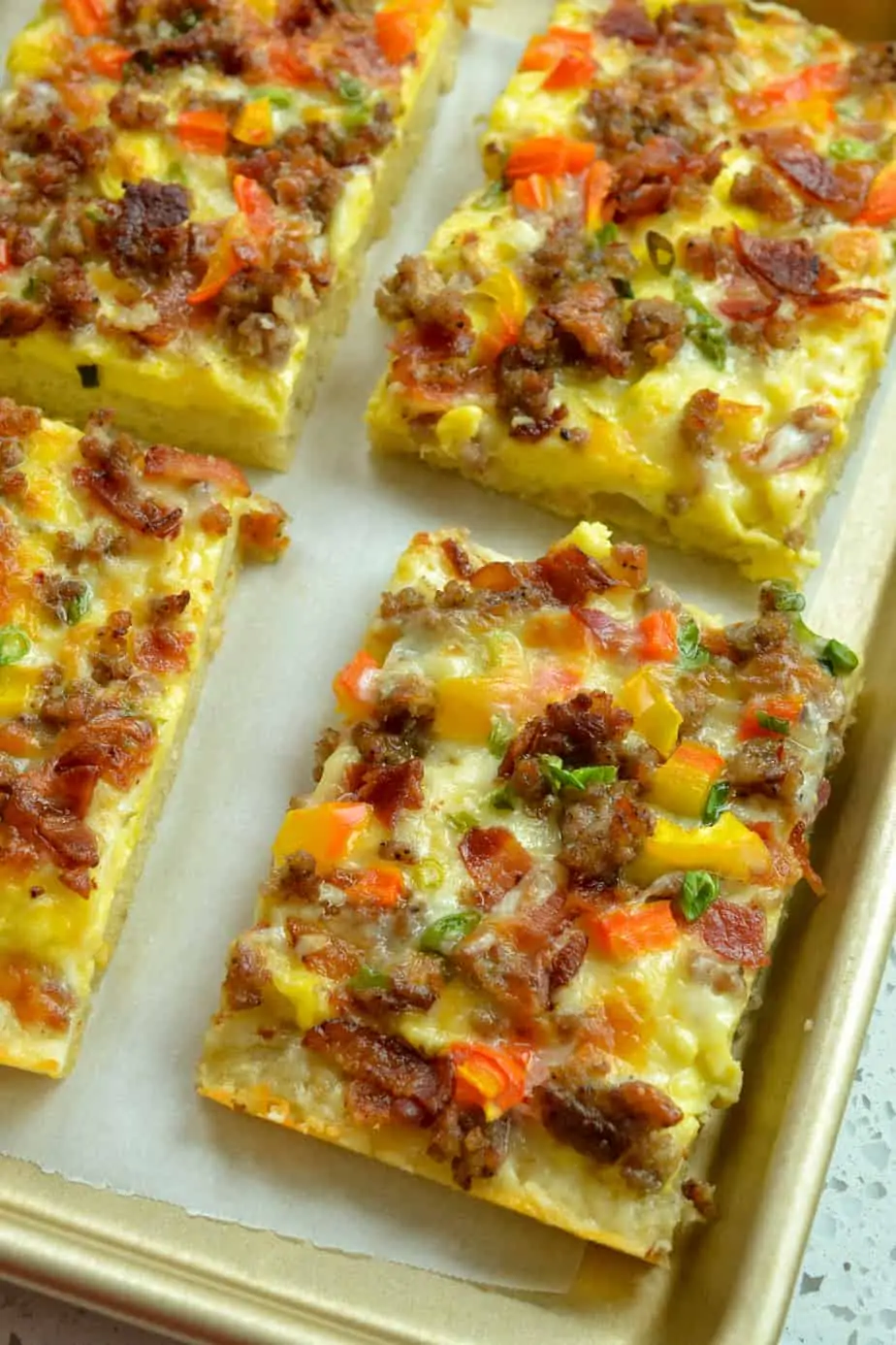Tasty Breakfast Pizza combines crispy bacon, sausage, sweet peppers, green onions and cheese on a fresh baked pizza crust. 