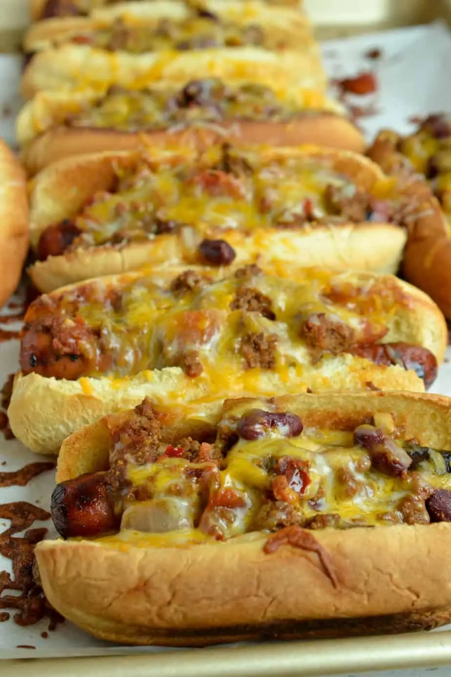 The best Chili Cheese Dogs with a robust hearty thick chili over grilled hot dogs and topped with oodles of cheese.