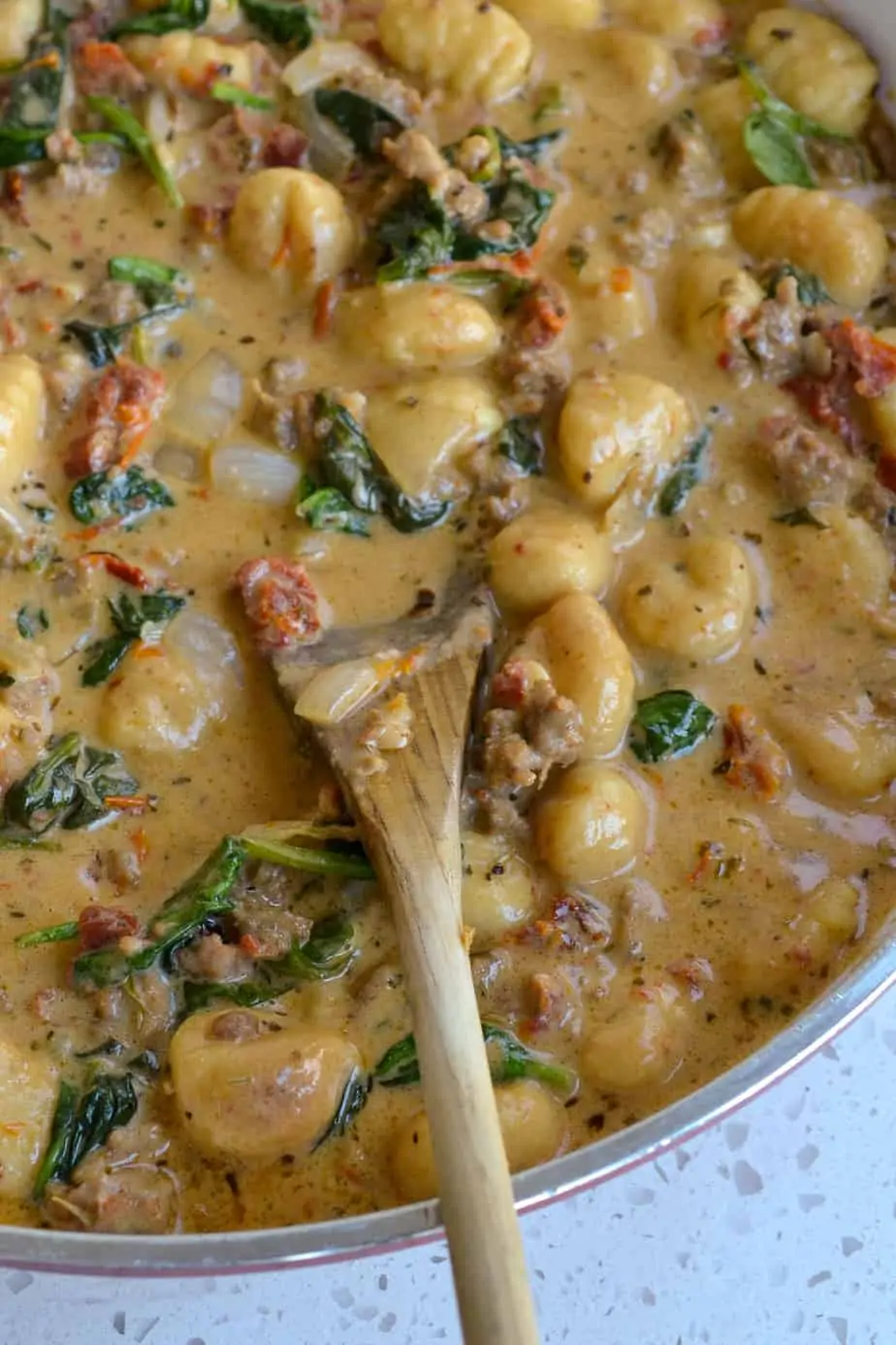 This Creamy Gnocchi Pasta Recipe with Italian Sausage and spinach is the ultimate comfort meal with a creamy Parmesan Sauce. 