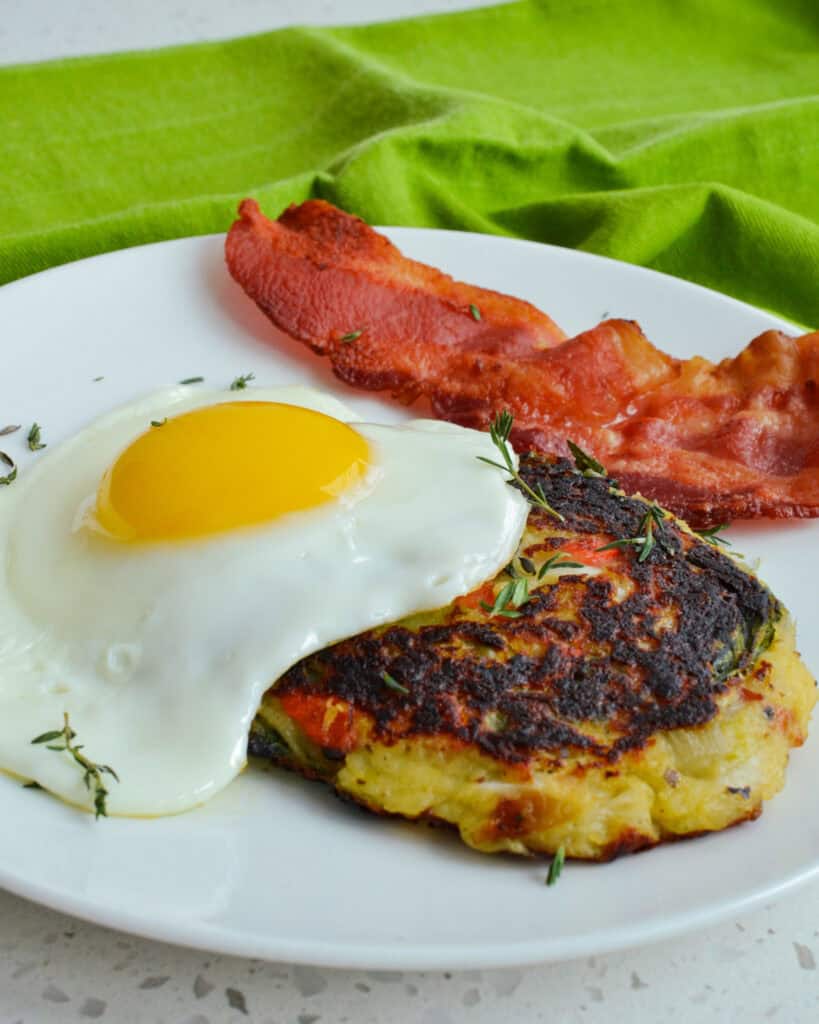 Top the bubble and squeak with a sunny side up or poached egg and serve with a side of bacon. 
