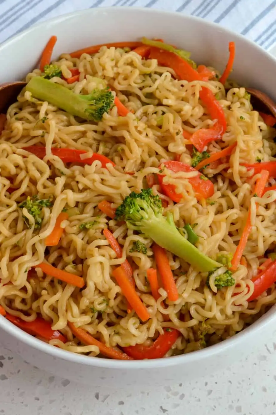 Noodle stir fry recipe with broccoli, red bell peppers, and carrots with an Asian sauce. 