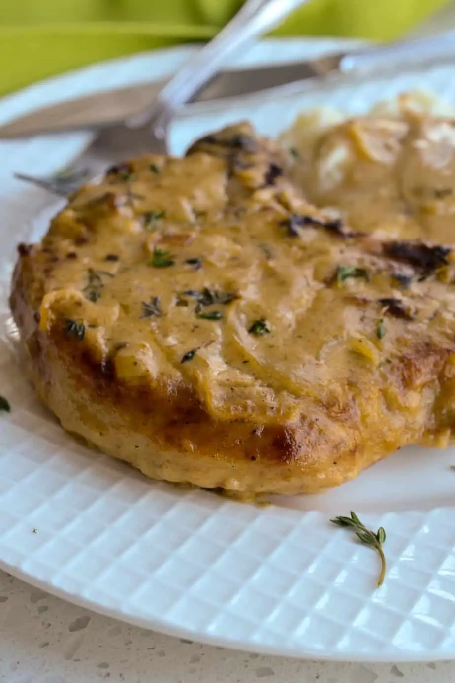 Southern-style breaded pork chops are smothered with a rich cream gravy seasoned with caramelized onions and garlic. Serve over mashed potatoes, rice, or egg noodles.