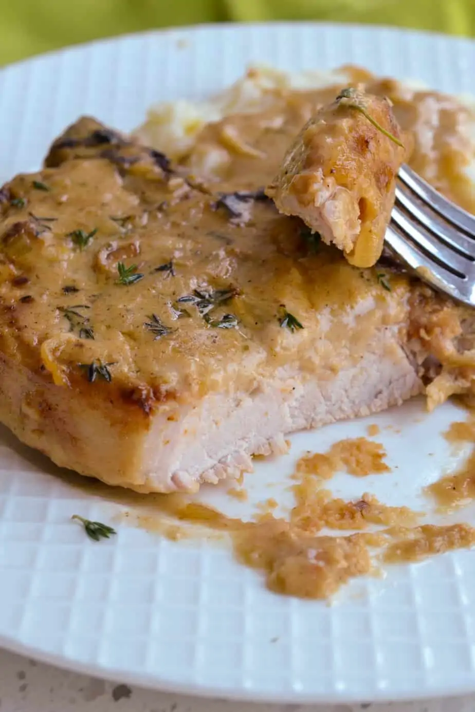 These classic Smothered Pork Chops are lightly breaded pork chops, pan-fried and drenched in a creamy and flavorful easy-to-make pan gravy. 