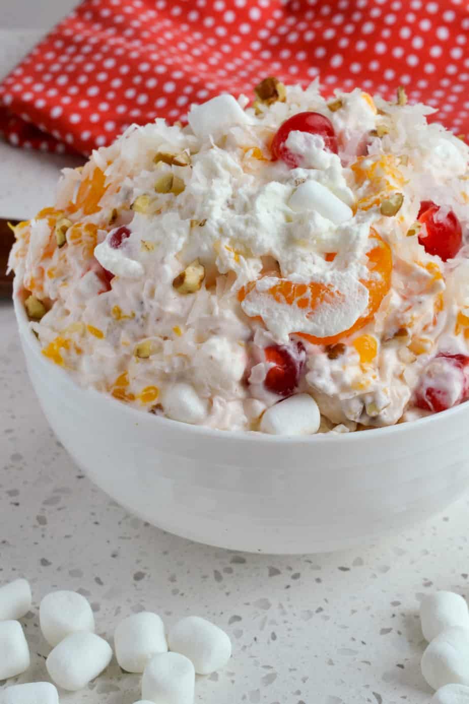 Fruit salad with nuts, marshmallows, and coconut.