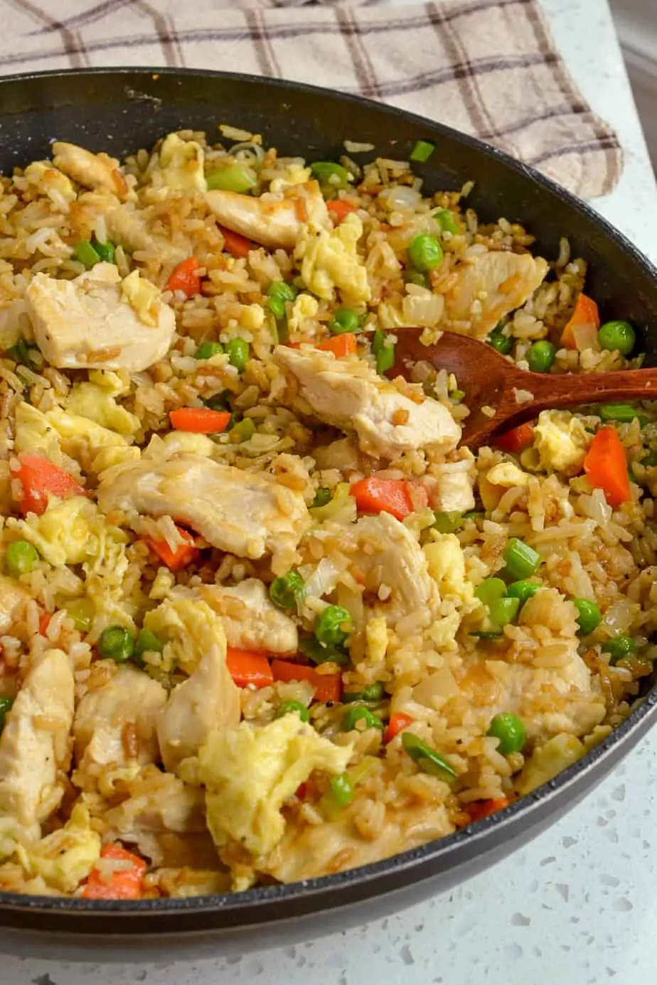 This easy Chicken Fried Rice is loaded with golden brown chicken, sweet onions, carrots, peas, eggs, and green onions and tastes so much better than your favorite Chinese take-out.