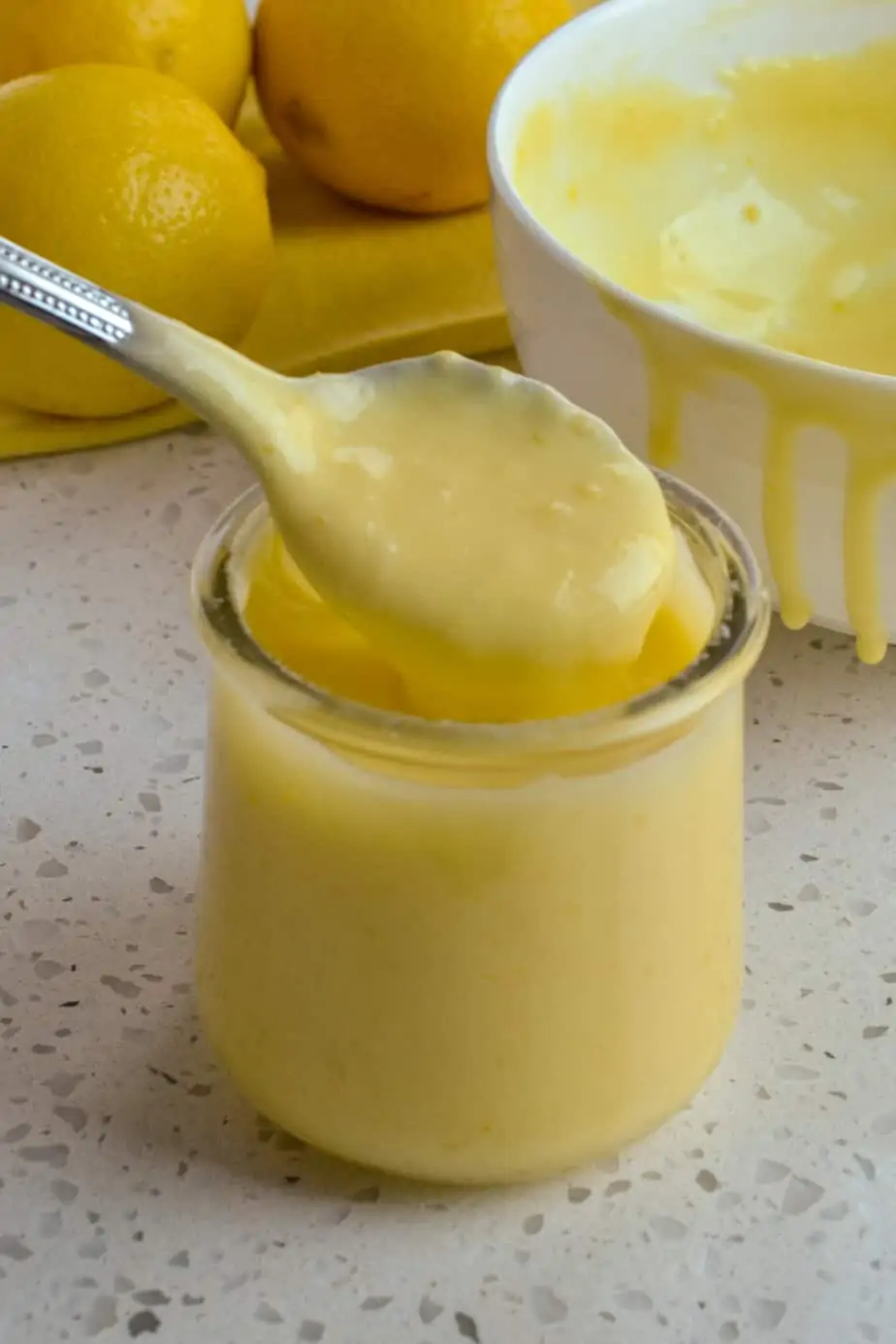 A bowl and a jar of sweet lemon curd. 