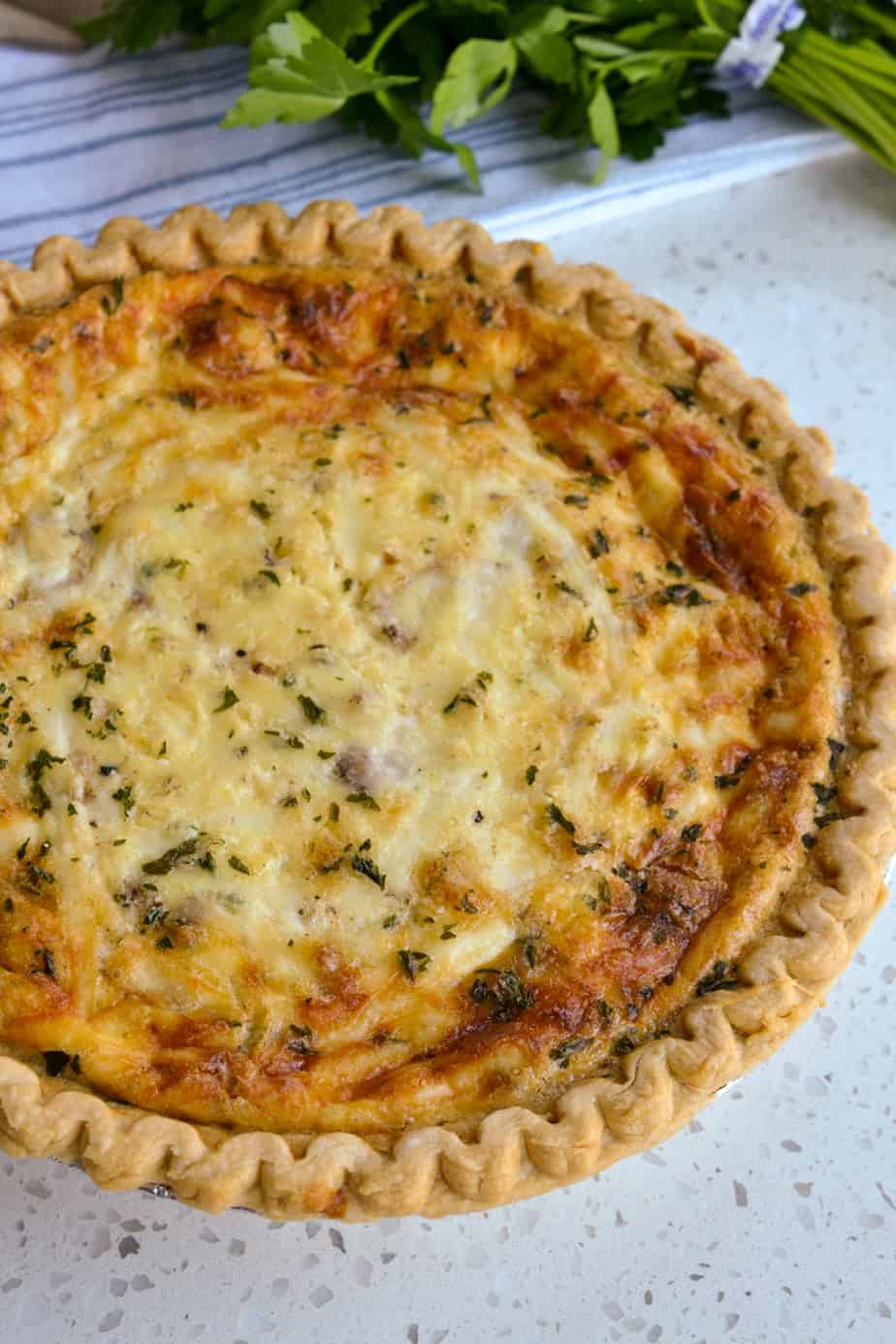 A beautiful lightly browned quiche straight out of the oven. 