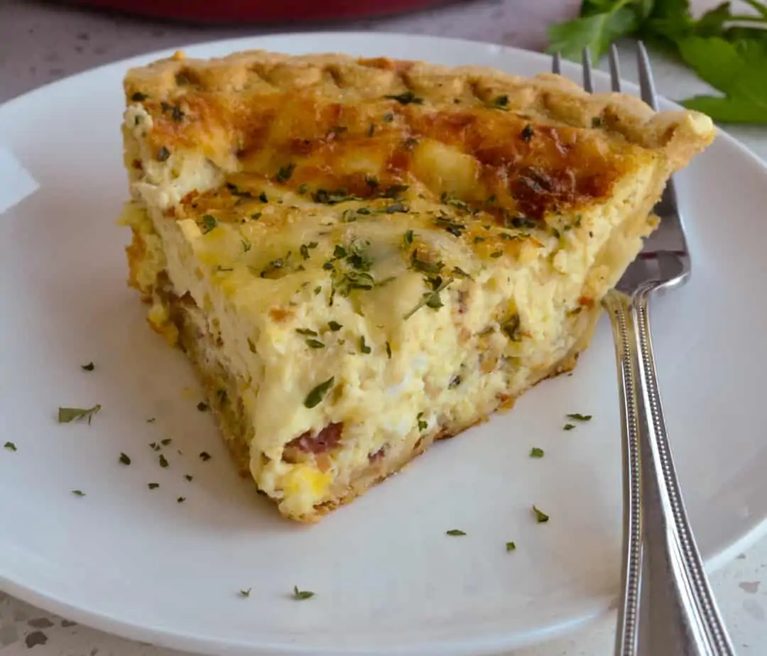 A slice of quiche on a plate