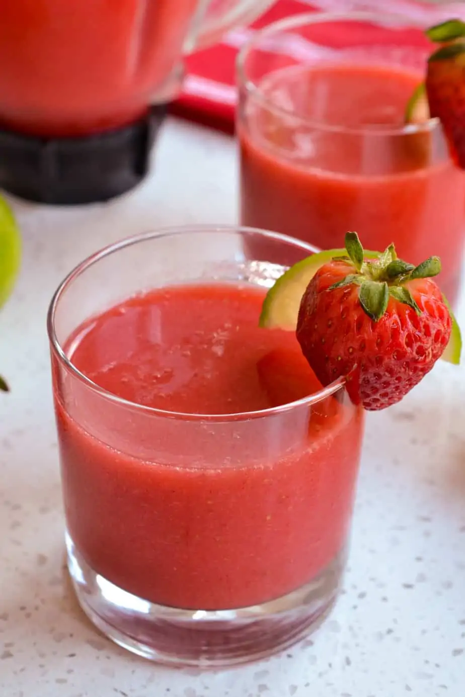 Two glasses full of strawberry cocktail